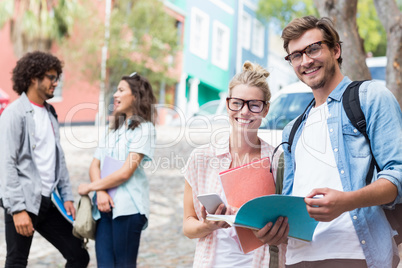 Portrait of students holding book