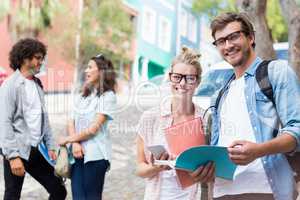 Portrait of students holding book