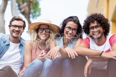 Portrait of friends sitting side by side