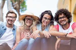 Portrait of friends sitting side by side