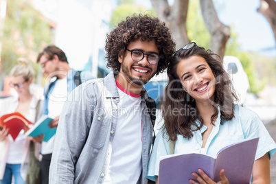 Portrait of students holding book