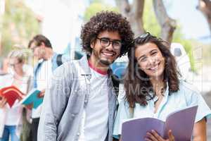 Portrait of students holding book