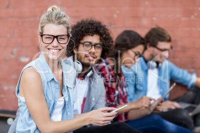 Friends sitting on roadside