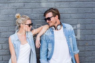 Young couple leaning against wall