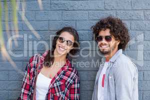 Young couple leaning against wall