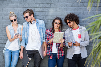 Friends leaning against wall