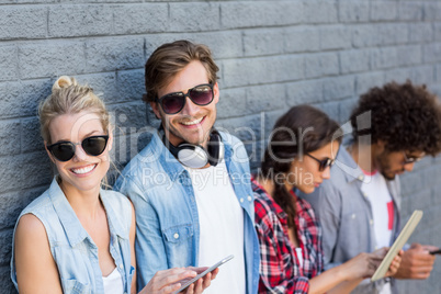 Friends leaning against wall