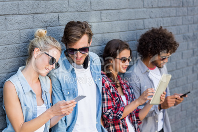 Friends leaning against wall