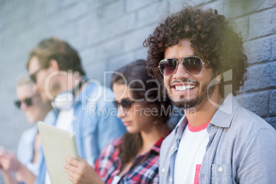 Young man in sunglasses smiling at camera