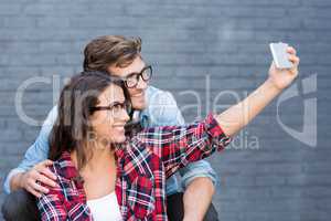 Young couple in spectacles taking a selfie