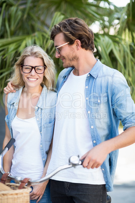 Young couple standing with bicycle