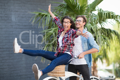 Young couple riding on a bicycle