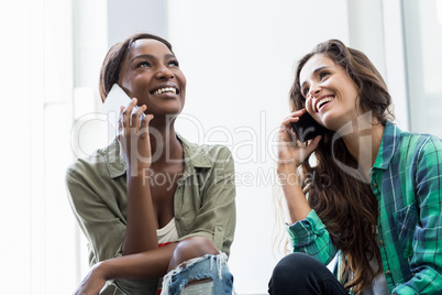 Friends talking on mobile phone