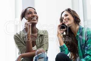 Friends talking on mobile phone