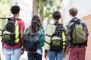 Friends standing with rucksack