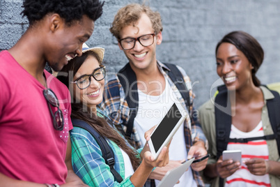 Woman showing digital tablet to her friends