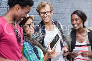 Woman showing digital tablet to her friends