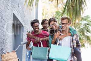 Young men giving piggyback to women