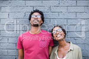 Young couple leaning against wall