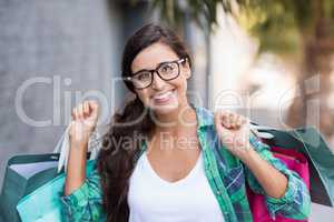 Portrait of young woman holding shopping bags