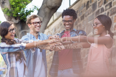 Friends putting their hands together