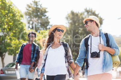 Happy young couple walking on road