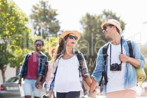 Happy young couple walking on road