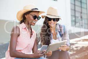 Young women using digital tablet and mobile phone