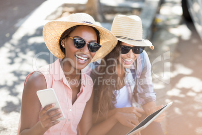 Young women using digital tablet and mobile phone