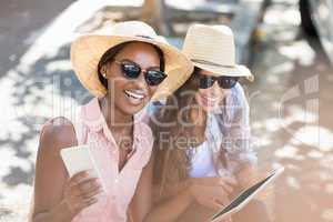 Young women using digital tablet and mobile phone