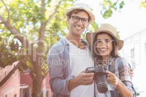 Portrait of young couple holding camera