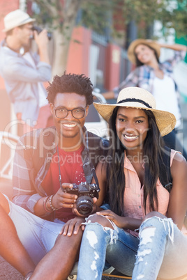 Portrait of couple holding camera