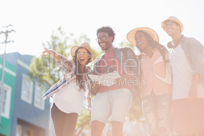 Friends holding map and pointing