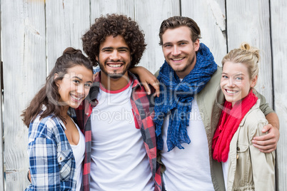 Friends standing with arms around