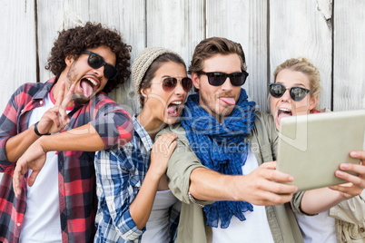 Friends taking selfie on digital tablet