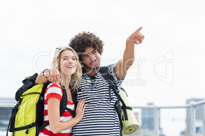 Man standing with woman pointing upwards