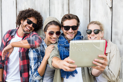 Friends taking selfie on digital tablet