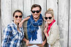 Friends in sunglasses using digital tablet