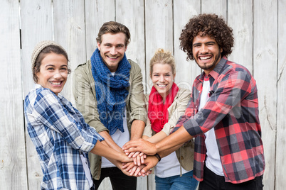 Friends putting their hands together