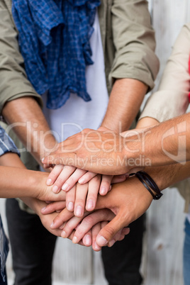 Friends putting their hands together