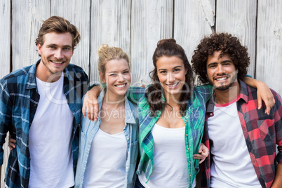 Friends standing with arms around