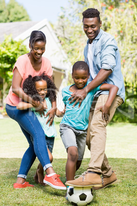 Happy family playing football