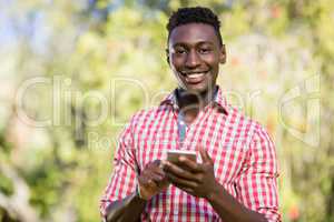 Happy man posing and holding his smartphone