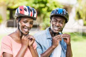 Happy couple wearing their helmet
