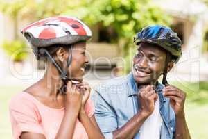 Happy couple wearing their helmet