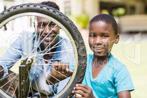 Happy family repairing a bike