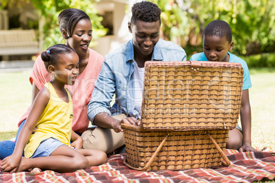 Happy family looking the wicker basket