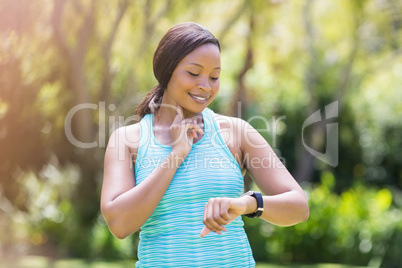 Happy woman posing and looking her watch