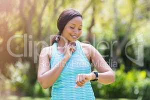 Happy woman posing and looking her watch