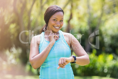 Happy woman looking her watch